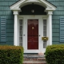 teal-green-shingle-house-with-red-door