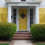 white-stucco-house-with-yellow-shutters