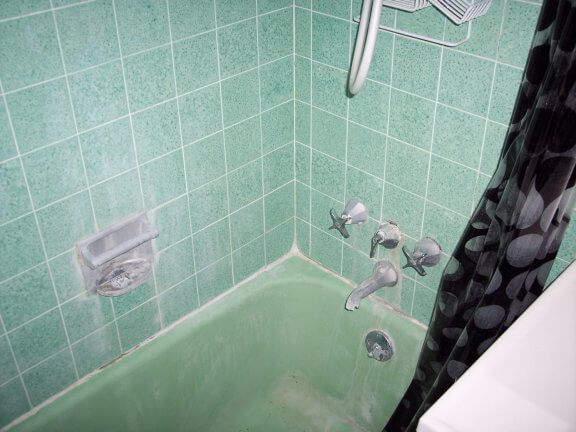  The bathroom started out with a hideous mottled green tile and green