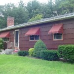 ranch house front with awnings