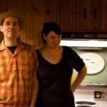 kelly and mark in their knotty pine kitchen