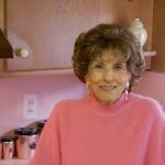 nora and her pink kitchen and pink and blue bathroom