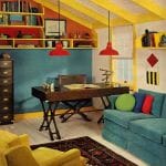 a 1970 attic design with blue sofa and orange pendant lighting
