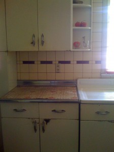 I think your vintage steel tile is wonderful. The color and design scream 40s deco. But honestly, if you want to ditch it so that you can bring your kitchen into the Atomic era, do it. 