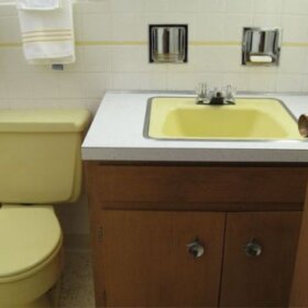 yellow bathroom sink and toilet