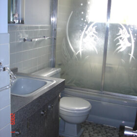 gray bathroom with vintage sliding shower doors