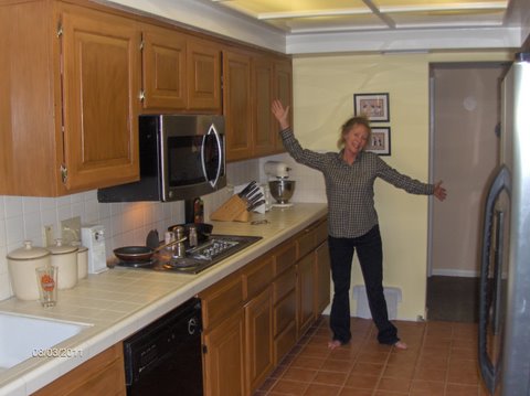 connie in her kitchen painted with rustoleum cabinet transformations