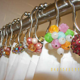 vintage earrings used to decorate shower curtain rods