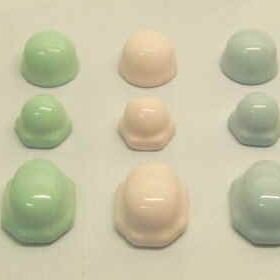 toilet bolt caps in pastel pink, green, blue, yellow and ivory