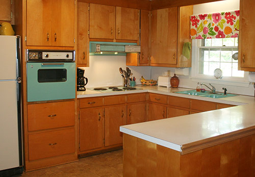 1963 kitchen with wood cabinets and aqua appliances and sink
