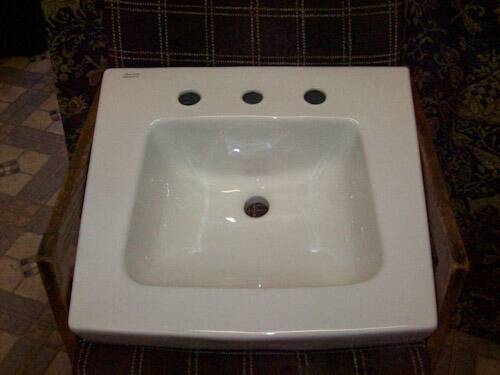 White ceramic 20 and a half inches x 19 and a half inches 8 inch spread wall hung lavatory sink