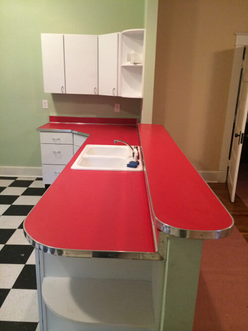 red kitchen counter top with metal trim