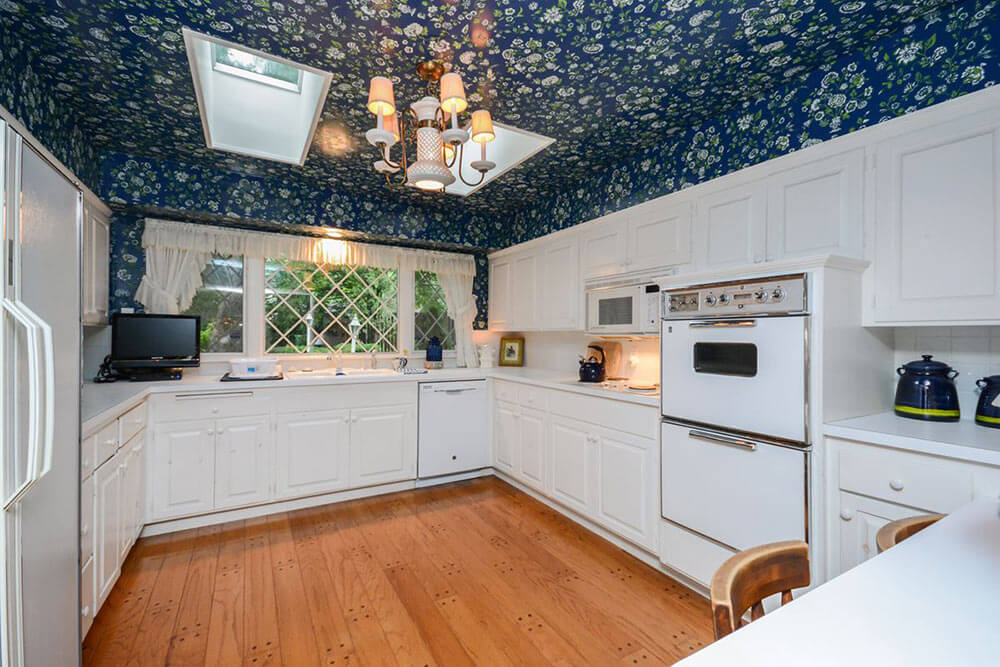 kitchen with wallpaper on the ceiling and soffits