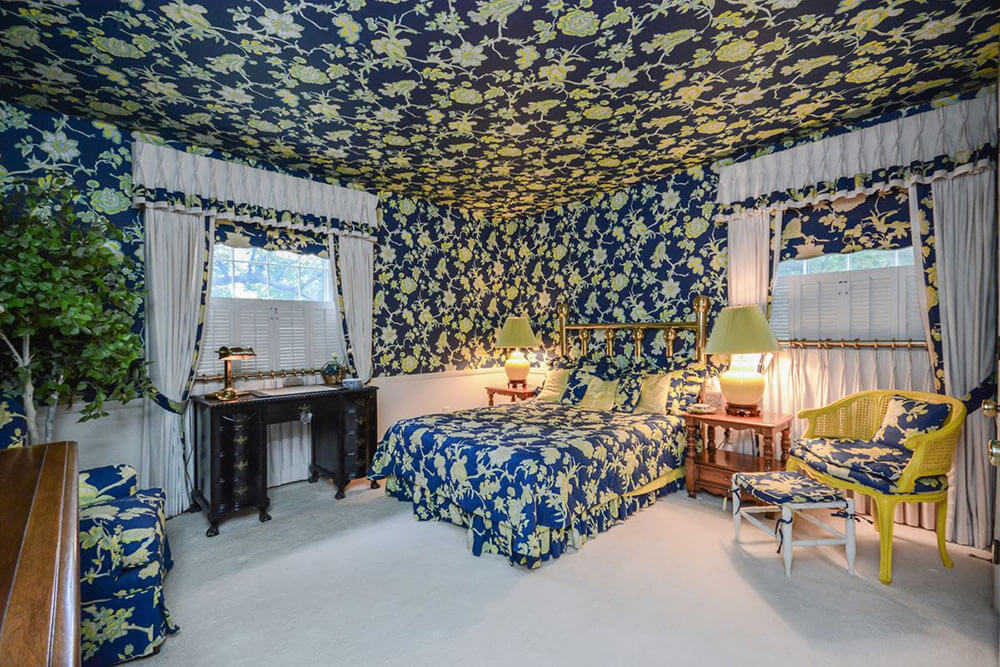 bedroom with wallpaper on the ceiling