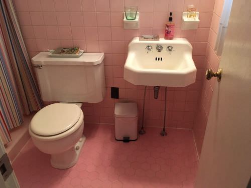 vintage pink bathroom with hexagon floor tile and square pink wall tiles