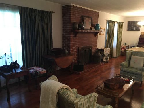 1958 living room with brick fireplace and original wood floors