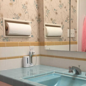 recessed ceramic paper towel holder in a bathroom