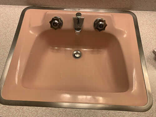 Formica Skylark boomerang laminate on a bathroom counter with a pink sink
