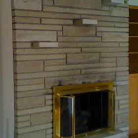 fireplace with built in stone shelves