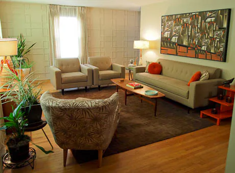 mid century modern living room with orange accessories