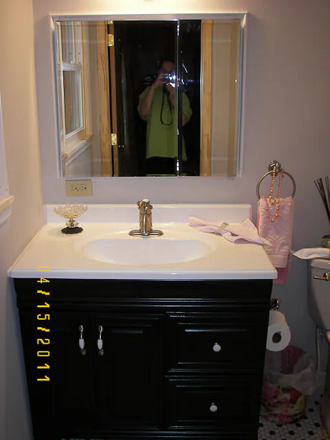 bathroom vanity painted black using rustoleum cabinet transformations kit