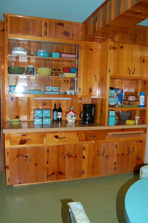built in shelves in mid century knotty pine kitchen