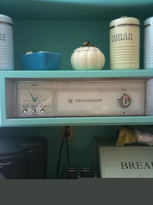 vintage-oven-panel-turned-into-art clock from vintage stove installed in new kitchen