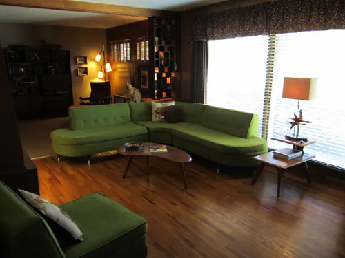 Retro Living room with curvy green couch Retro Living room with curvy green couch