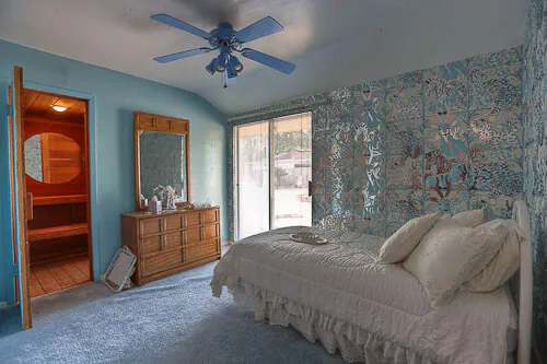 Fantastic 1960 time capsule house featured on RetroRenovation.com mylar wallpaper on the walls and ceiling of a bedroom