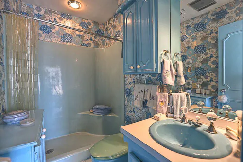 Fantastic 1960 time capsule house featured on RetroRenovation.com mylar wallpaper on the walls and ceiling of a bedroom