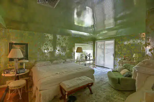 Fantastic 1960 time capsule house featured on RetroRenovation.com mylar wallpaper on the walls and ceiling of a bedroom