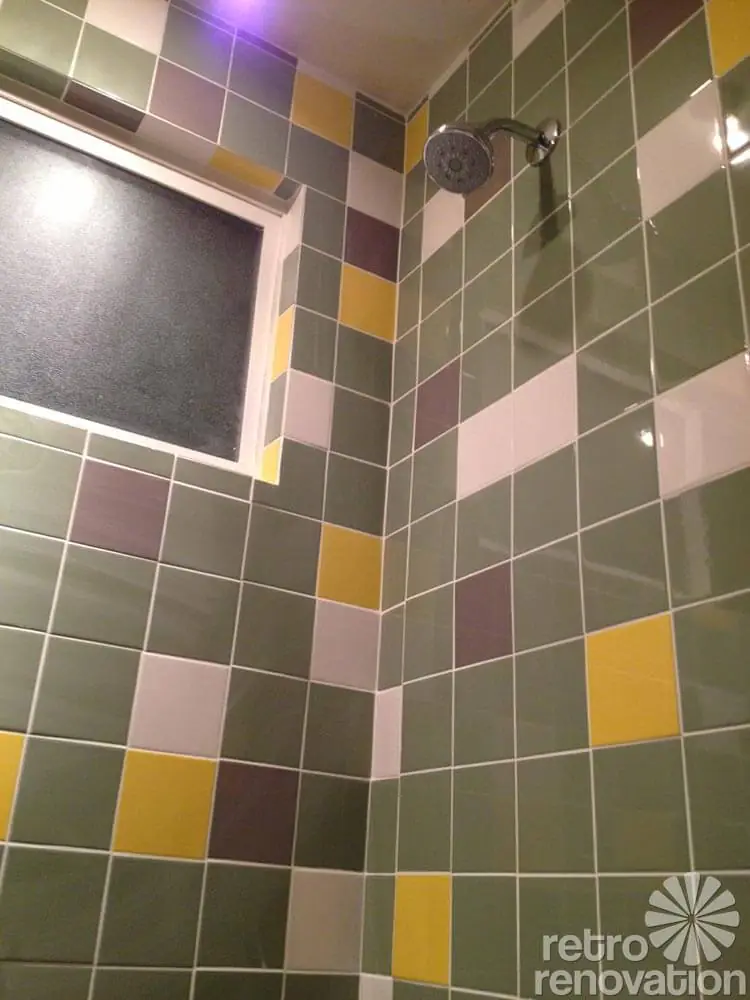 midcentury bathroom remodel green tile in the shower
