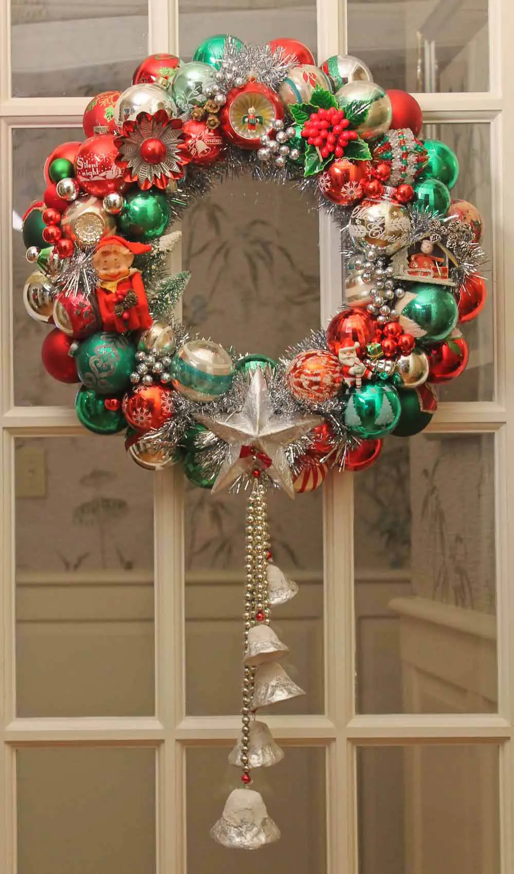 chrismas ornament wreath with hanging bells made from vintage ornaments
