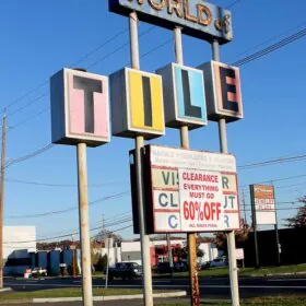 world of tile sign