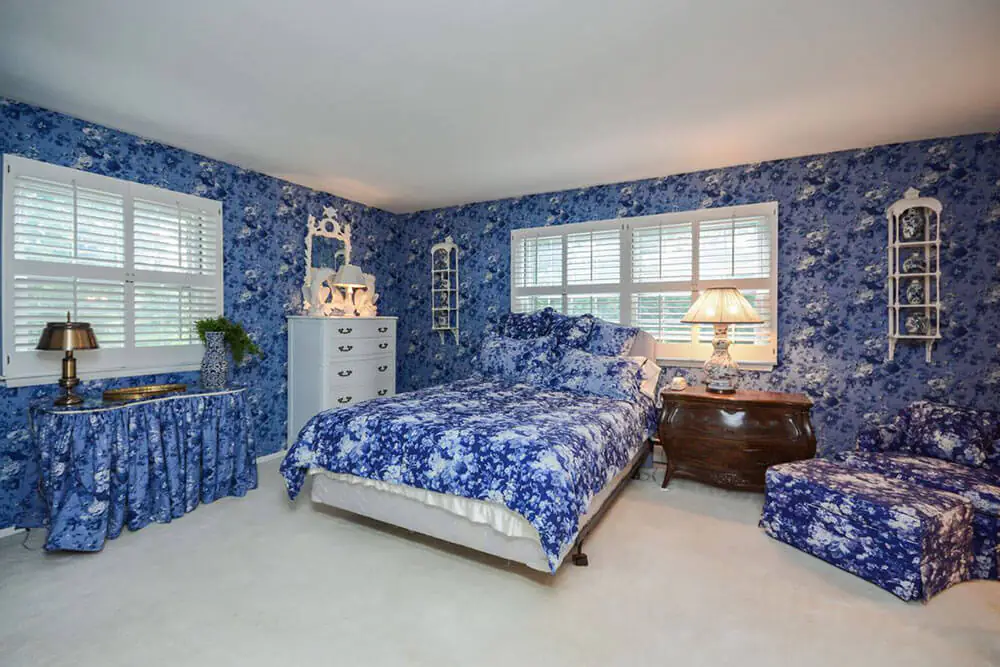 bedroom with matching wallpaper and upholstery
