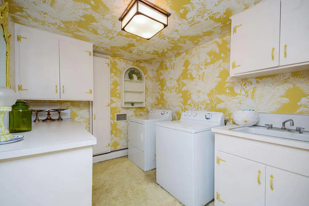 laundry room with yellow wallpaper