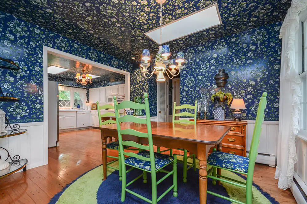 dining room with blue wallpaper on the walls and ceiling