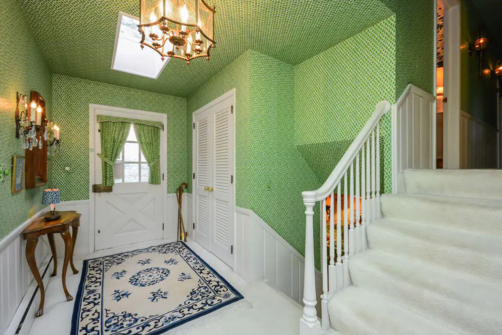 foyer with wallpaper on the walls and ceiling