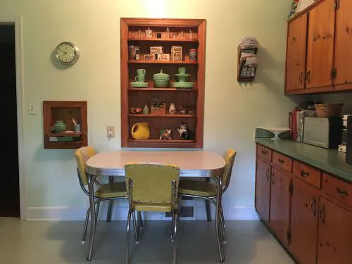cute knotty pine kitchen with small dinette and built in shelving
