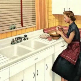 homemaker working at a double sink in her 1950s kitchen