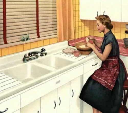 homemaker working at a double sink in her 1950s kitchen