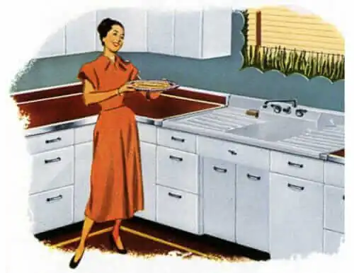 Woman working at a single sink with drainboards in her 1940s kitchen